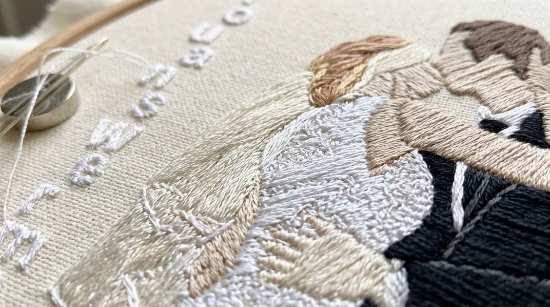Close-up of hand embroidery thread detail on custom couple sweatshirt