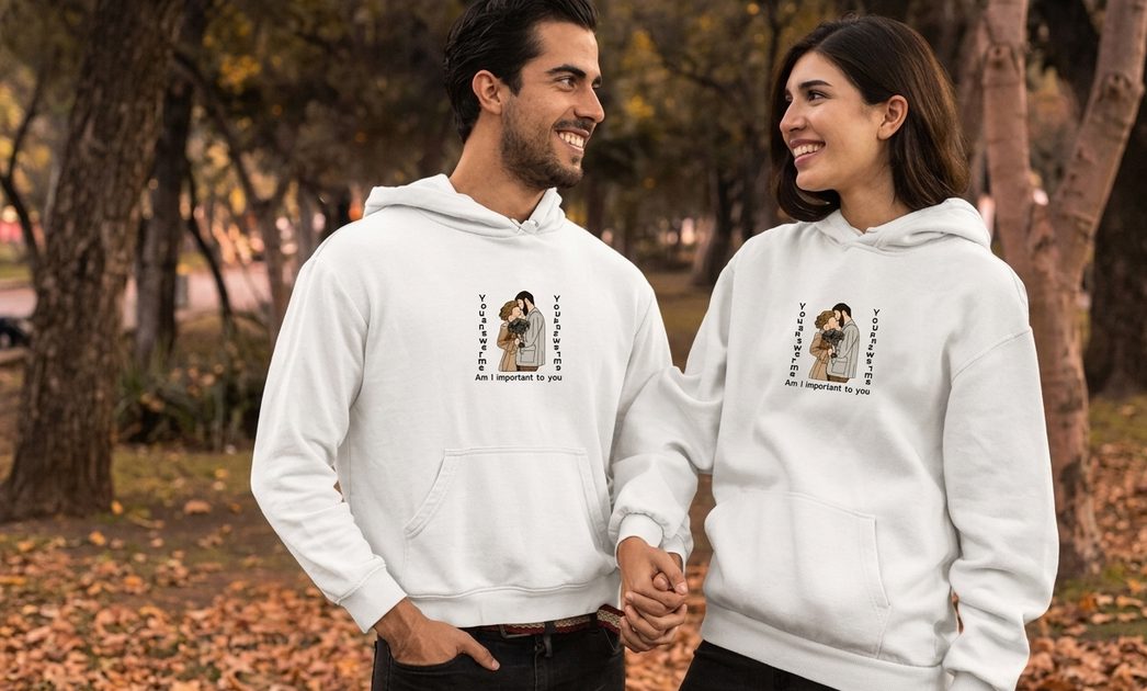 Couple wearing matching custom embroidered hoodies outdoors